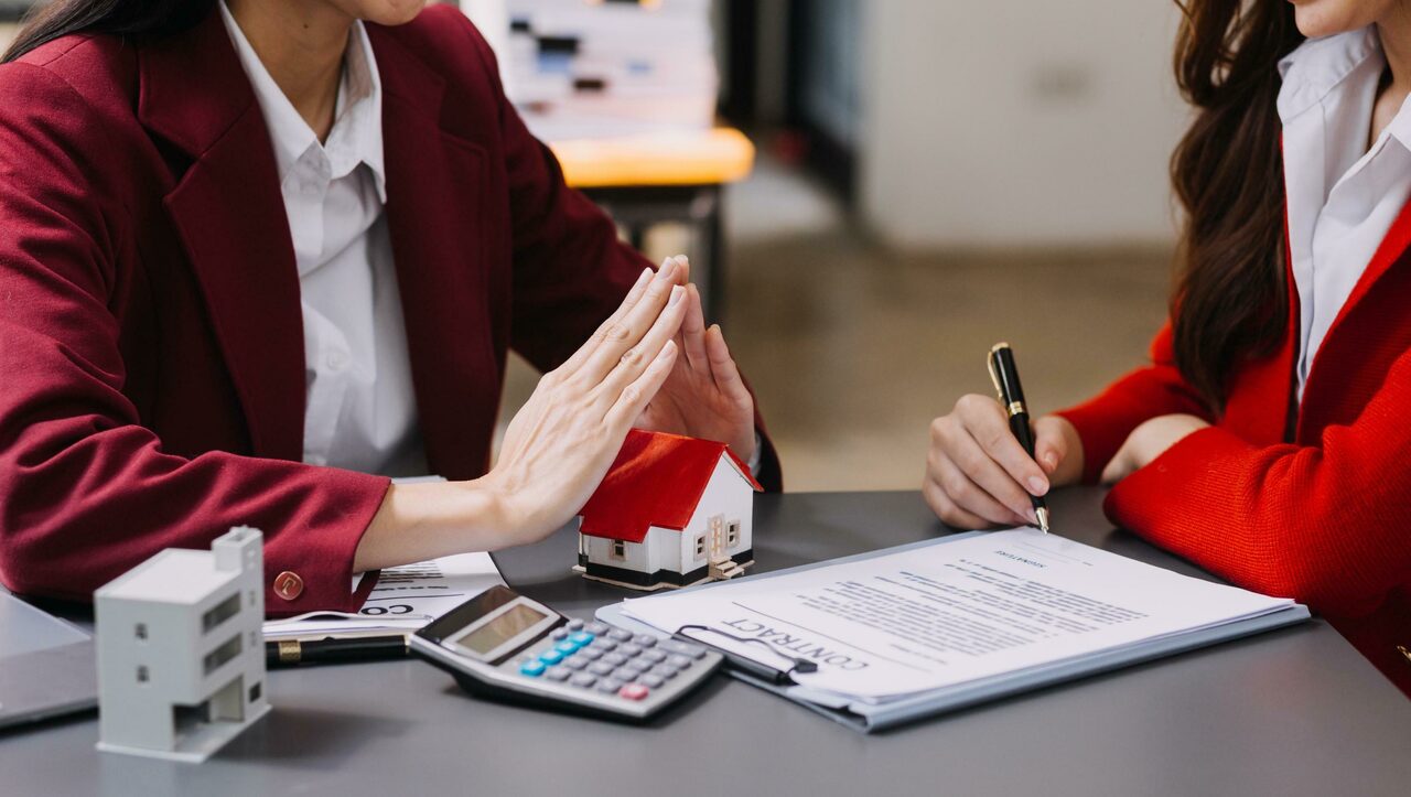 Discussion with a real estate agent house model with agent and customer discussing for the contract to buy get insurance or loan real estate or property free photo