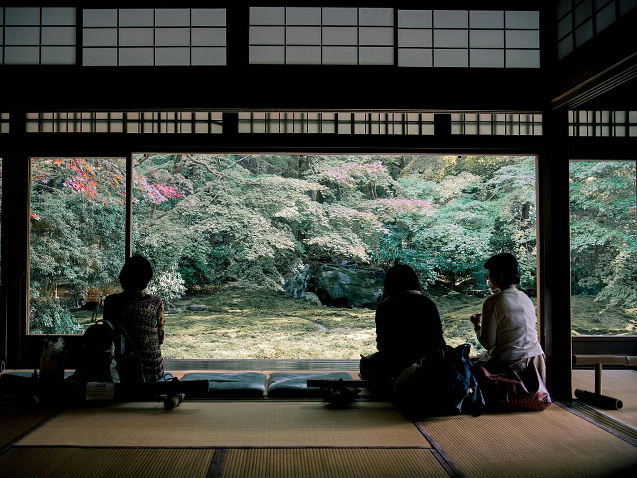 Three women sitting on mats Satoshi Hirayama